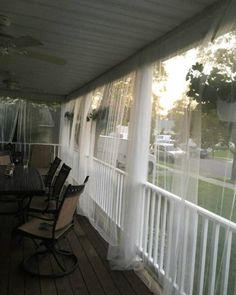 the back porch is covered with sheer curtains