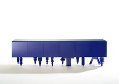 a blue sideboard with three legs on it