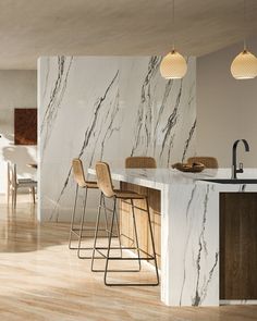 a kitchen with marble counter tops and bar stools