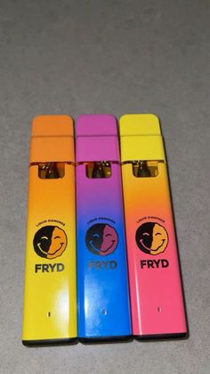 four different colored lighters sitting next to each other on a counter top with the words frydd written on them