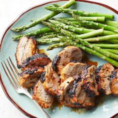 grilled meat and asparagus on a plate