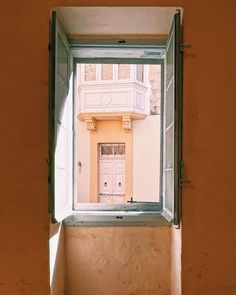 an open window with a white door in it