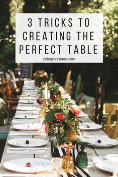 a long table with white plates and flowers on it is set up for an outdoor dinner