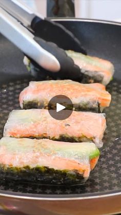 three pieces of salmon being cooked in a frying pan