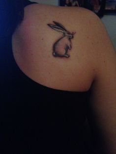 a woman with a rabbit tattoo on her shoulder