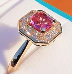 Beautifull Pink Sapphire as an Octagon Shape.1.05ct 5.7 x 5.7 x3 mm VVS set in Deco Vintage Style 18ct Yellow gold Ring with Calibre Setting.Diamonds = 8 x princess cut & 4 x trillion cut G/VS Grade 0.68ct Total Diamond Weight.(Certificate can be supplied on request for added fee ,please message for more info) Gia Certified Pink Sapphire Rings For Formal Occasions, Gia Certified Classic Pink Sapphire Jewelry, Classic Gia Certified Pink Sapphire Jewelry, Gia Certified Gold Cluster Jewelry, Gia Certified Yellow Gold Cluster Ring, Formal Pink Sapphire Diamond Ring With Halo Setting, Gia Certified Yellow Gold Sapphire Ring With Diamonds, Fine Jewelry Gold Ruby Ring Gia Certified, Gia Certified Yellow Gold Ruby Ring For Anniversary