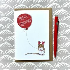 a card with a mouse holding a red balloon that says merry christmas on it and the words,