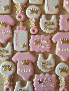 baby shower cookies decorated with pink and gold royal ones, diapers, shoes, crowns