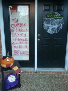 two halloween decorations sitting in front of a door with the words the chamberer of secrets has been opened