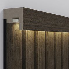 a wooden wall with a light on the side and some lights above it that are lit up