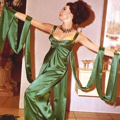 a woman in a green dress is dancing