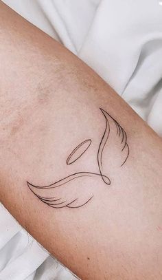 a woman's arm with a bird tattoo on the left side of her arm