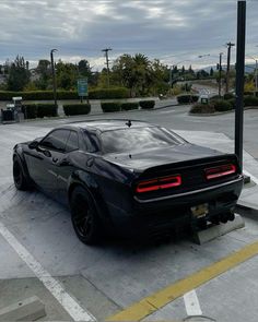 a black sports car parked in a parking lot