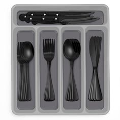 an assortment of utensils and spoons in a tray