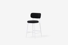 a black and white stool against a white background with the seat upholstered to it's back