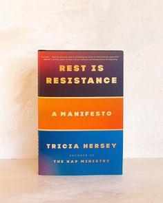 three books stacked on top of each other in front of a white wall with the title rest is resistance