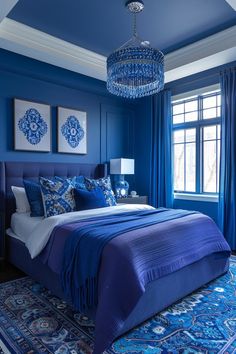 a bedroom with blue walls and carpeted flooring has a chandelier hanging from the ceiling