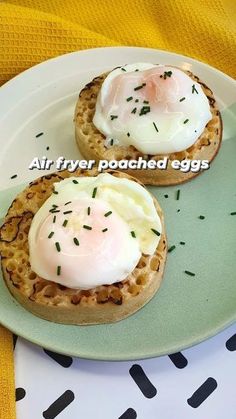 two open faced sandwiches with eggs on them are sitting on a green and white plate