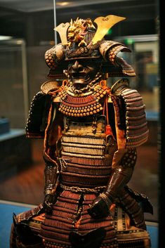 an elaborately decorated samurai statue on display in a glass case