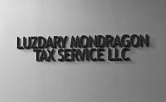 a metal sign that says luxury nondragon tax service llc