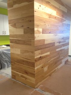 a wood paneled wall is being installed in an office