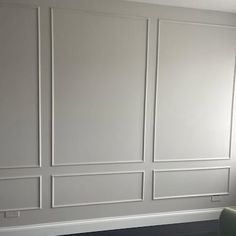 a living room with white walls and wood floors