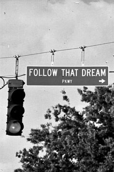 a black and white photo with the words follow that dream above it is a traffic light