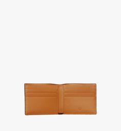 Small Bifold Wallet in Visetos Original Cognac | MCM ®US Luxury Leather Card Holder With Coin Pocket, Luxury Wallets With Interior Card Slots For Business, Formal Rectangular Wallet With Card Slots, Luxury Business Wallets With Interior Card Slots, Classic Rectangular Wallets With Interior Card Slots, Classic Rectangular Wallet With Interior Card Slots, Leather Business Card Holder With Interior Slots, Leather Trifold Wallet With Card Slots For Business, Saffiano Leather Wallets With Card Slots For Everyday Use