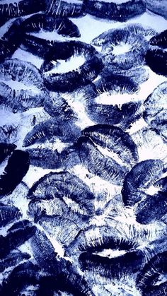 an image of many feathers that are in the water and one is black with white on it