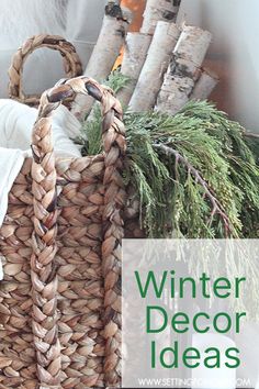 a wicker basket filled with pine cones and evergreen branches sitting on top of a table