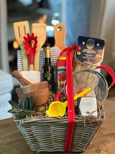 a basket filled with cooking utensils on top of a wooden table