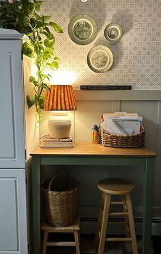 a green table with two stools next to it and a potted plant on top