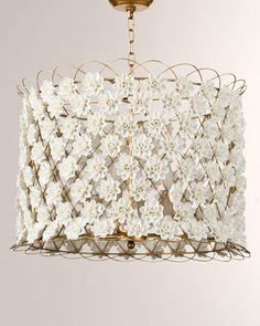 a chandelier with white flowers hanging from the ceiling