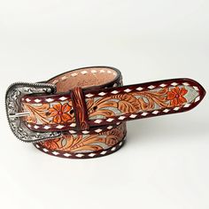 two leather belts with floral designs on them