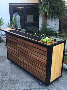 a wooden planter with plants growing out of it