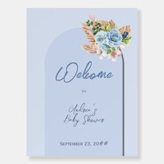 a welcome card with blue flowers and leaves on the front, in pastel tones