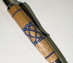 a pen that is sitting on top of a white surface with blue and black lines