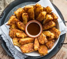 fried food on a plate with dipping sauce