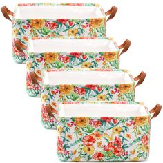 four floral print storage bags with brown handles