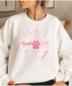 Are you looking for a fun gift for your favorite animal person? Check out this sweatshirt! It has a fun heart and paw design on the sleeve. Order yours today! Ideal for any situation, a unisex heavy blend crewneck sweatshirt is pure comfort. These garments are made from polyester and cotton. This combination helps designs come out looking fresh and beautiful. The collar is ribbed knit, so it retains its shape even after washing. There are no itchy side seams on these sweaters.  .: Made with a medium-heavy fabric blend of 50% cotton and 50% polyester (8.0 oz/yd² (271.25 g/m this sweatshirt feels cozy and is the perfect choice for those colder months. .: The classic fit along with the crew neckline deliver a comfy wearing experience with a clean-cut style. Meanwhile, the double-needle stitch Vet Tech Shirt, Vet Tech Gifts, Vet Assistant, Vet School, Tech Gift, Paw Design, Tech Shirt, Favorite Animal, Vet Tech