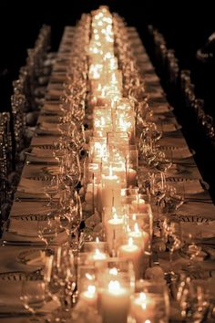 a long table with many candles on it