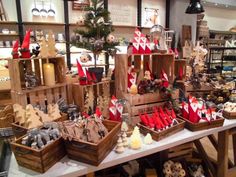 many wooden boxes filled with different types of christmas decorations and figurines on display