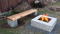 a wooden bench sitting next to a fire pit