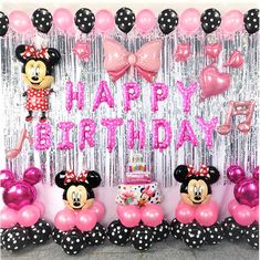 a birthday party with minnie mouse balloons and streamers