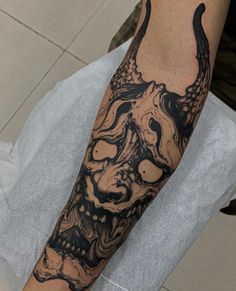 a man with a tattoo on his arm has a skull and an octopus in it