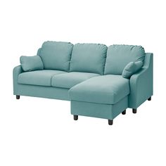 a blue sectional couch with pillows on the arm and foot rest in front of it