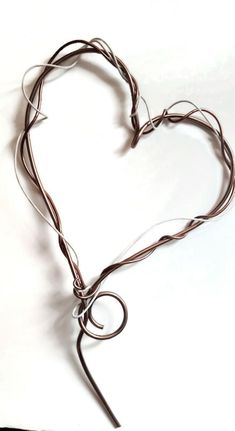 a heart - shaped wire sculpture on a white background