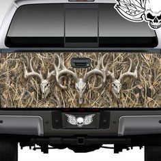 the back end of a truck with deer heads on it