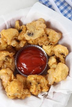 a basket filled with fried food and ketchup