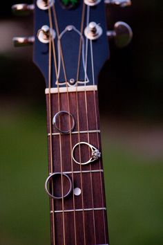 an acoustic guitar with three rings on it